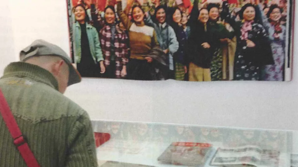 photo of Chinese man watching photo exhibition