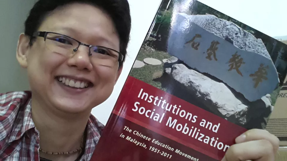 Dr. Ming-Chee Ang with book