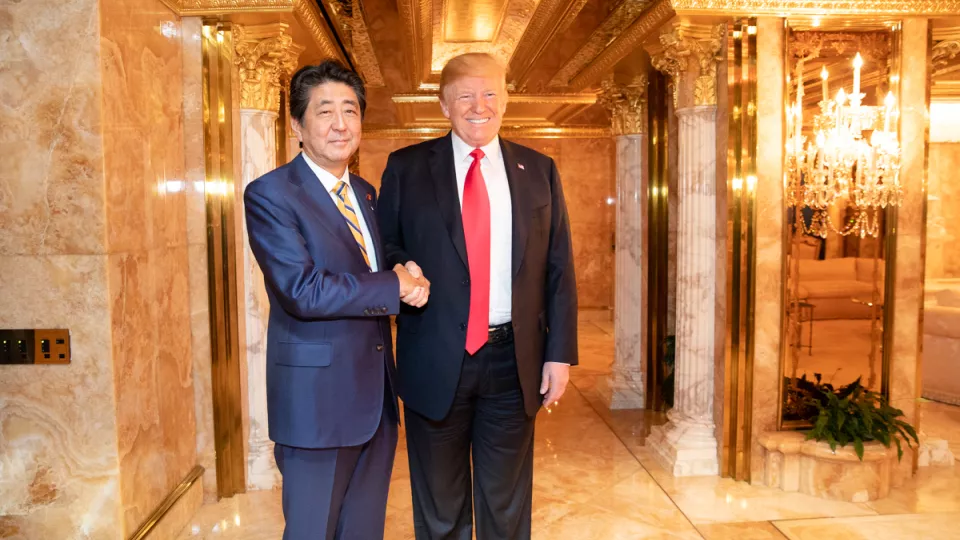 Shinzo Abe and Donald Trump shaking hands. Photo.