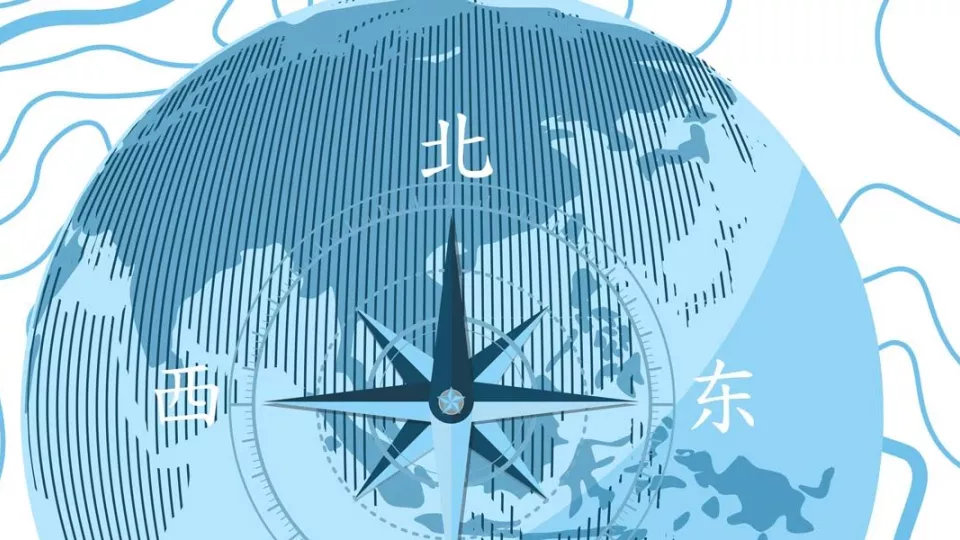 a blue globe with a compass and the cardinal directions in Chinese