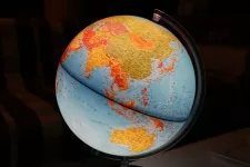 blue and yellow globe, Asia in focus, black background. photo.