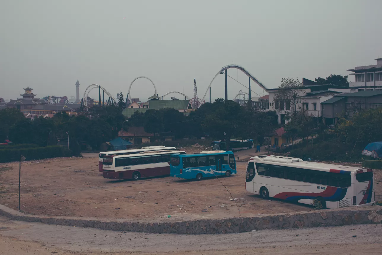 Abandoned busses in dusty parking lot outside Ha Long City, Vietnam. Photo