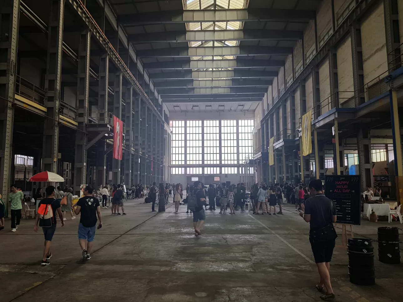 Inside an old warehouse in Singapore. people walkig around. Photo.